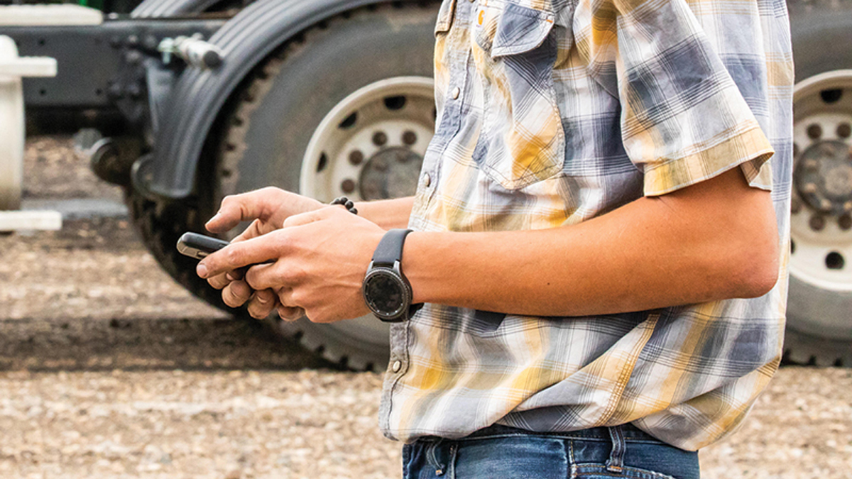 Man's arms holding a smartphone