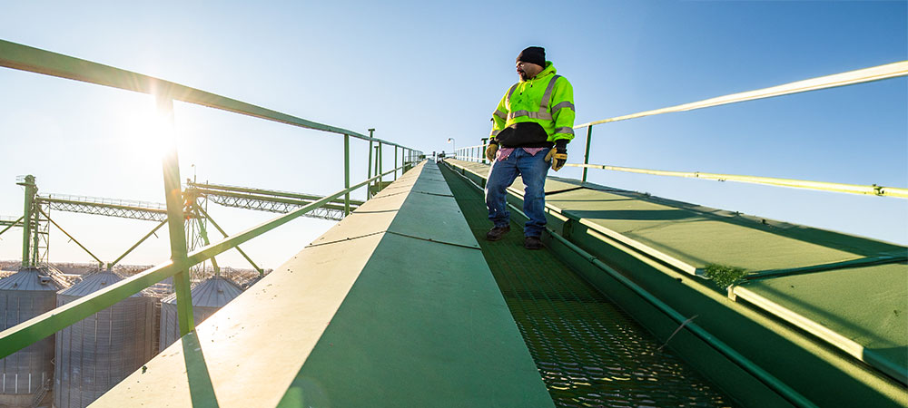 Employee standing outside at a grain elevator